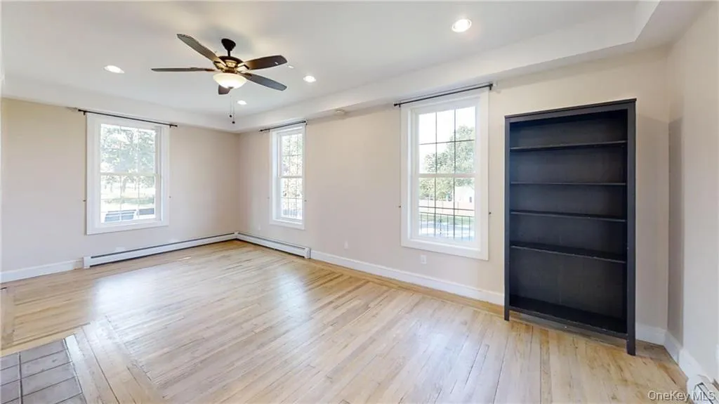 Spare room with light wood-style floors, recessed lighting, a ceiling fan, and baseboard heating Spare room with light wood-style floors, recessed lighting, a ceiling fan, and baseboard heating