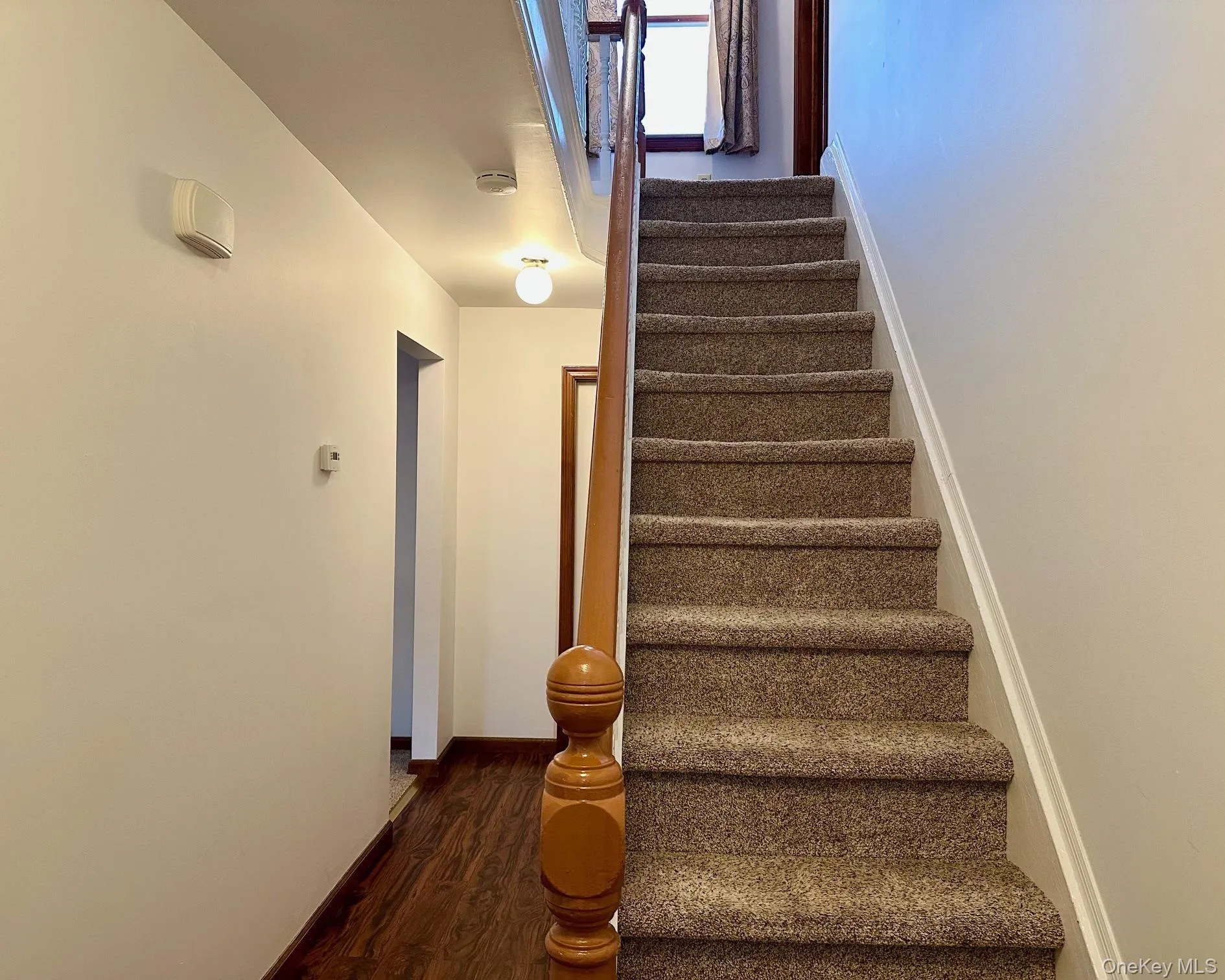 Staircase with wood finished floors and baseboards Staircase with wood finished floors and baseboards
