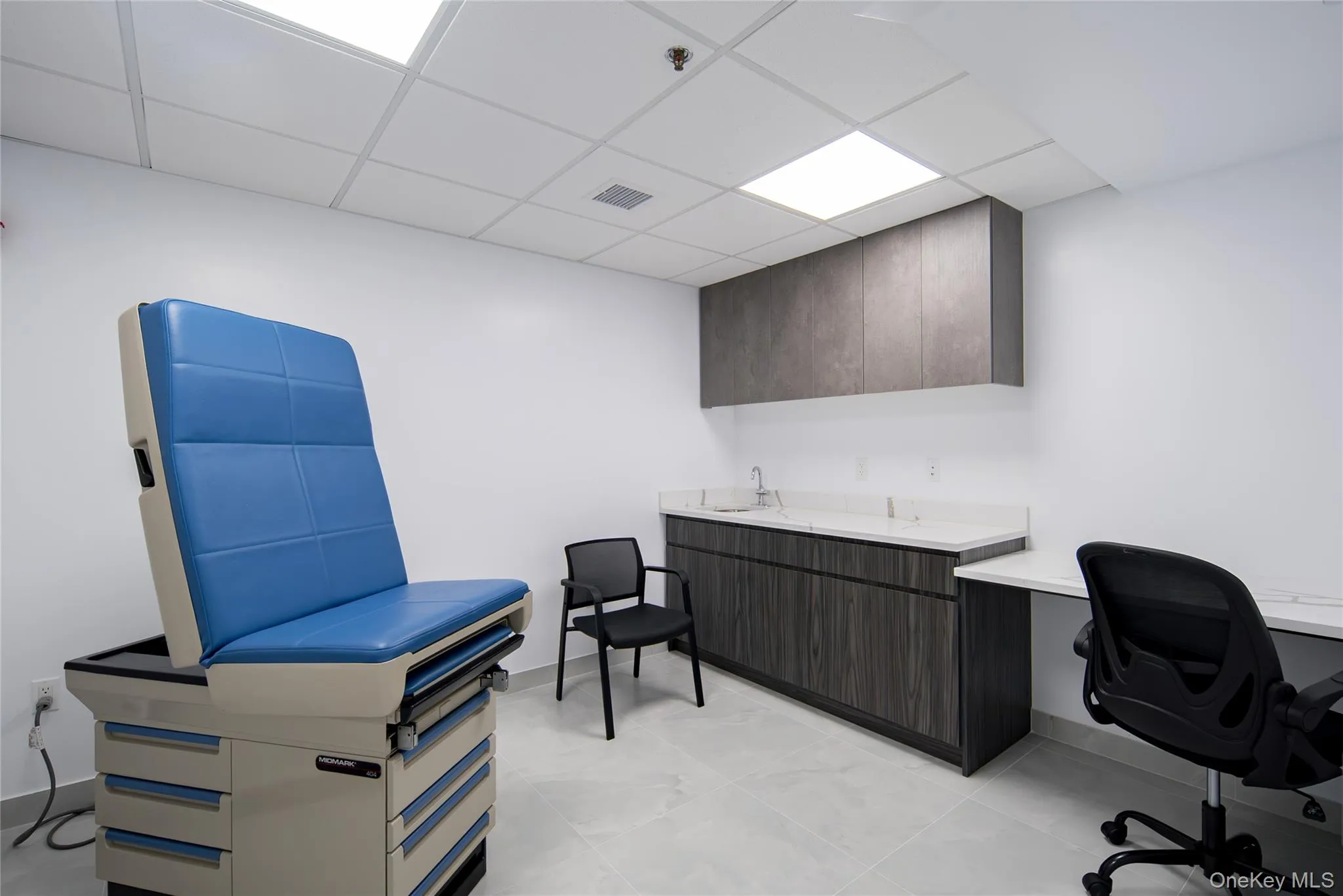 Misc room featuring a paneled ceiling and an office area Misc room featuring a paneled ceiling and an office area