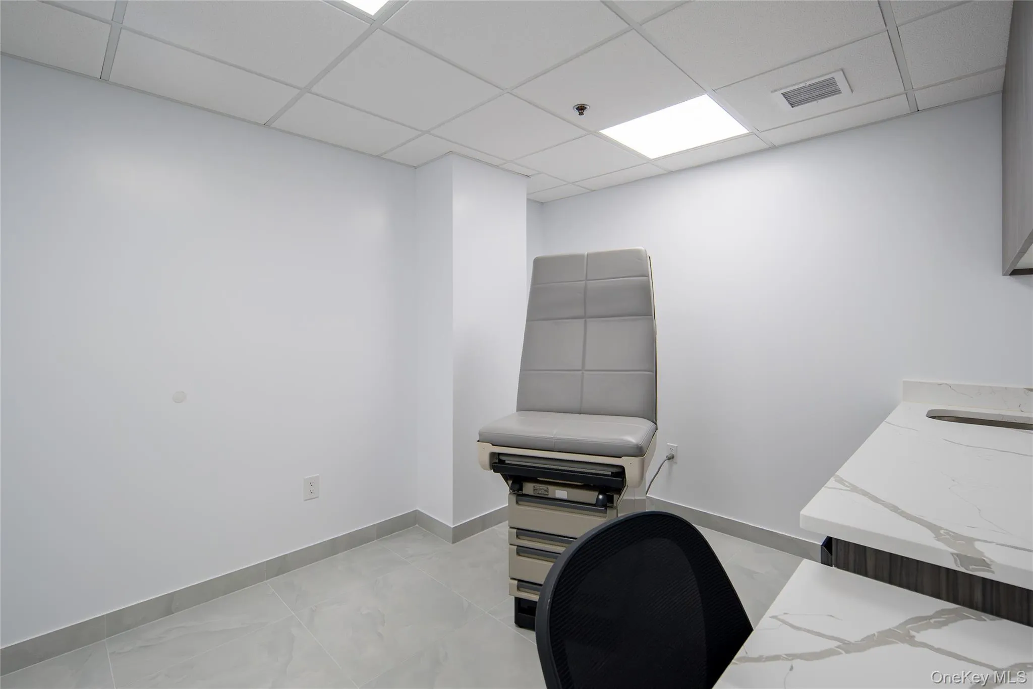 Office space featuring baseboards and a paneled ceiling Office space featuring baseboards and a paneled ceiling