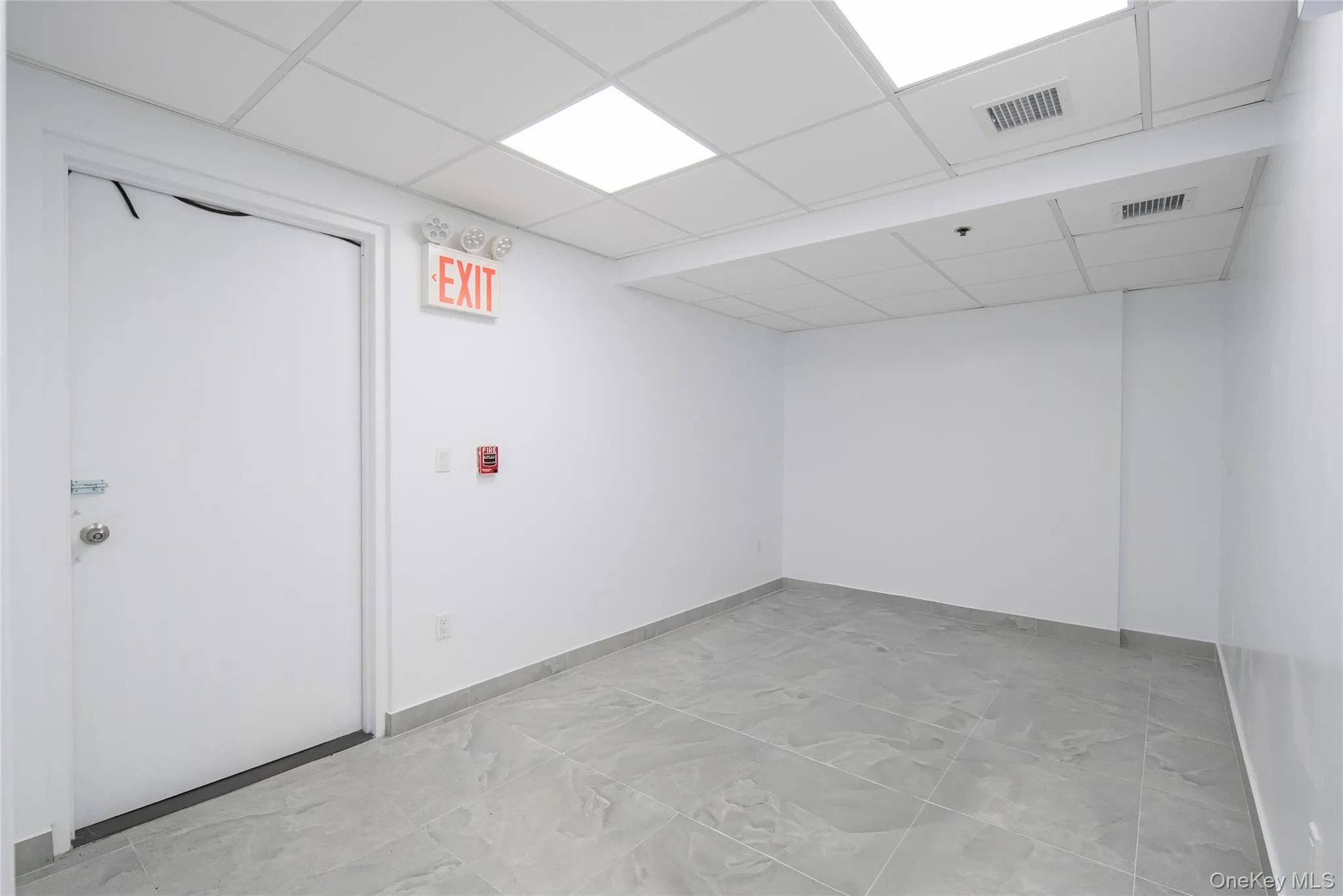 Finished basement with baseboards and a drop ceiling Finished basement with baseboards and a drop ceiling