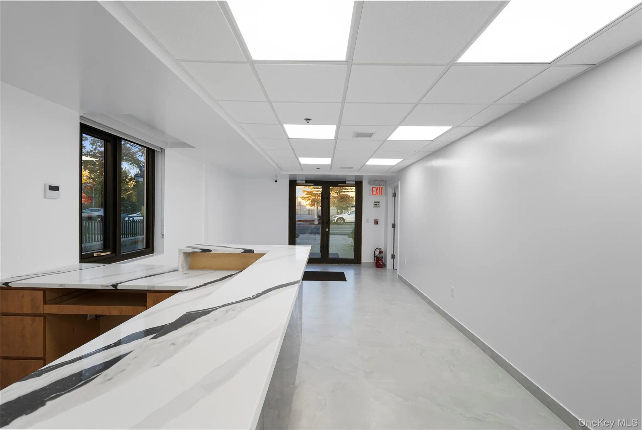 Corridor featuring a paneled ceiling and french doors Corridor featuring a paneled ceiling and french doors