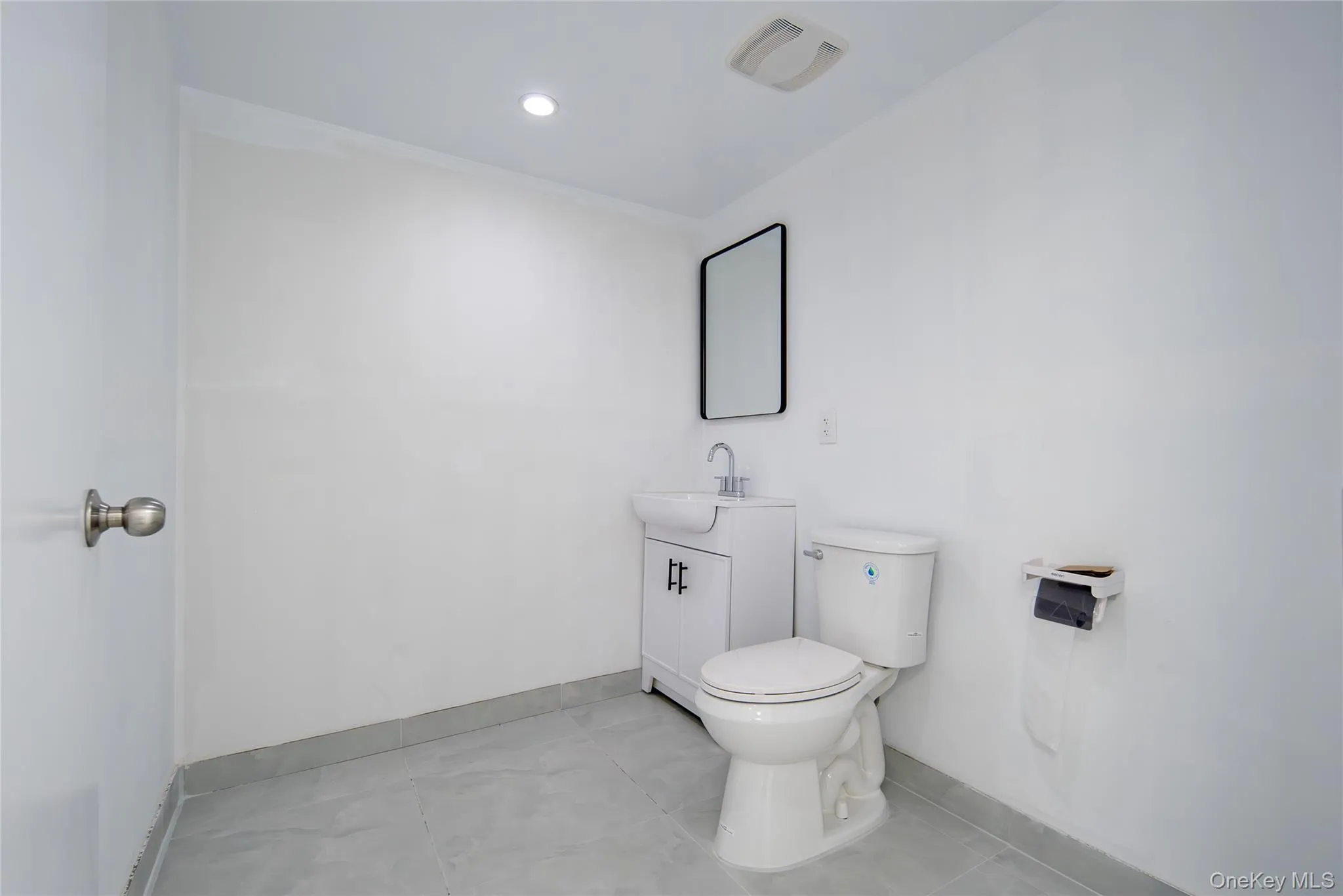 Bathroom with vanity, tile patterned flooring, and recessed lighting Bathroom with vanity, tile patterned flooring, and recessed lighting