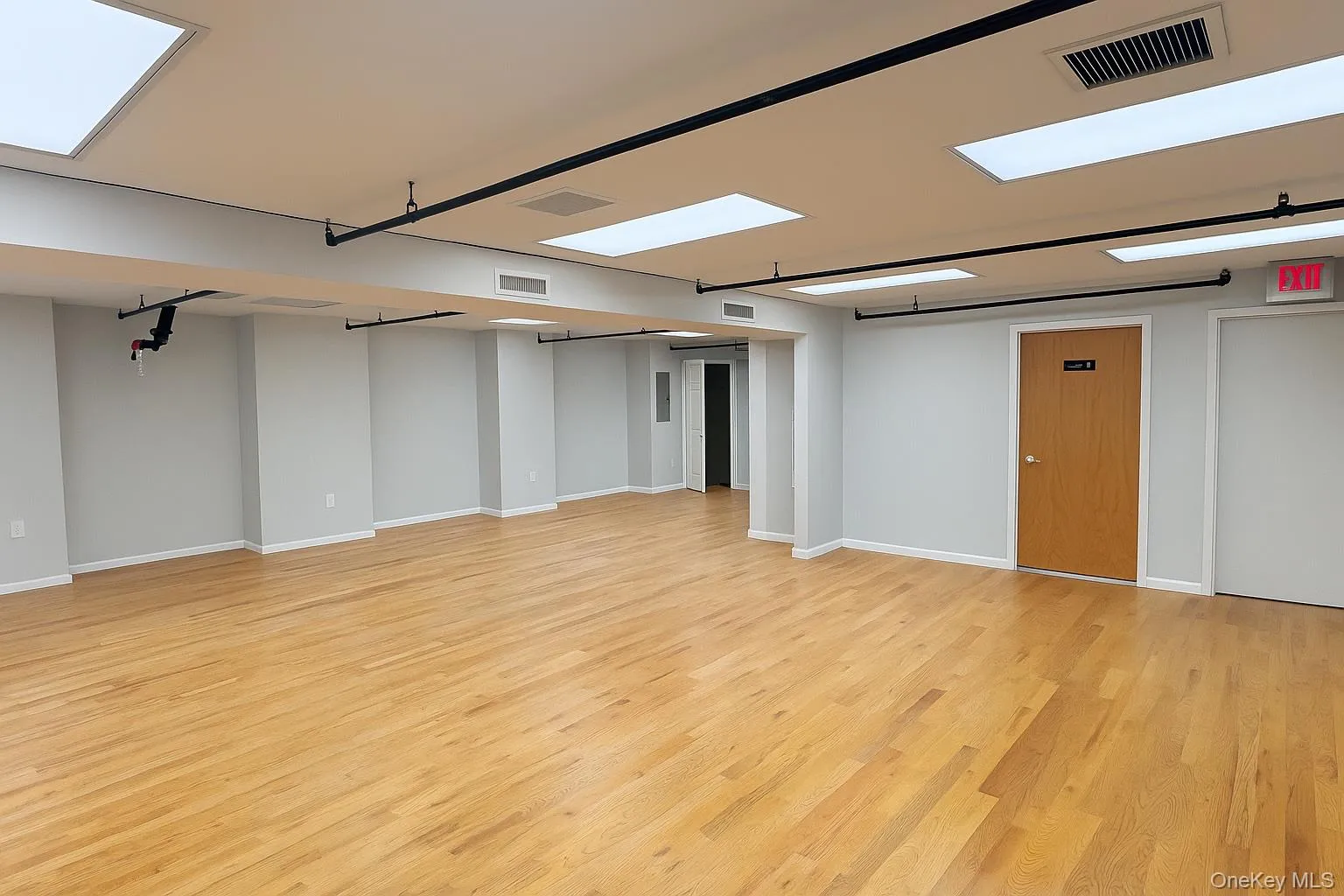 Below grade area featuring light wood-style flooring and baseboards Below grade area featuring light wood-style flooring and baseboards