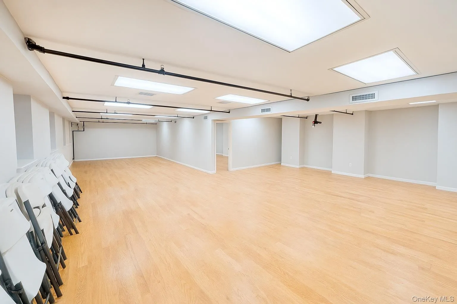 Below grade area featuring light wood-type flooring and baseboards Below grade area featuring light wood-type flooring and baseboards