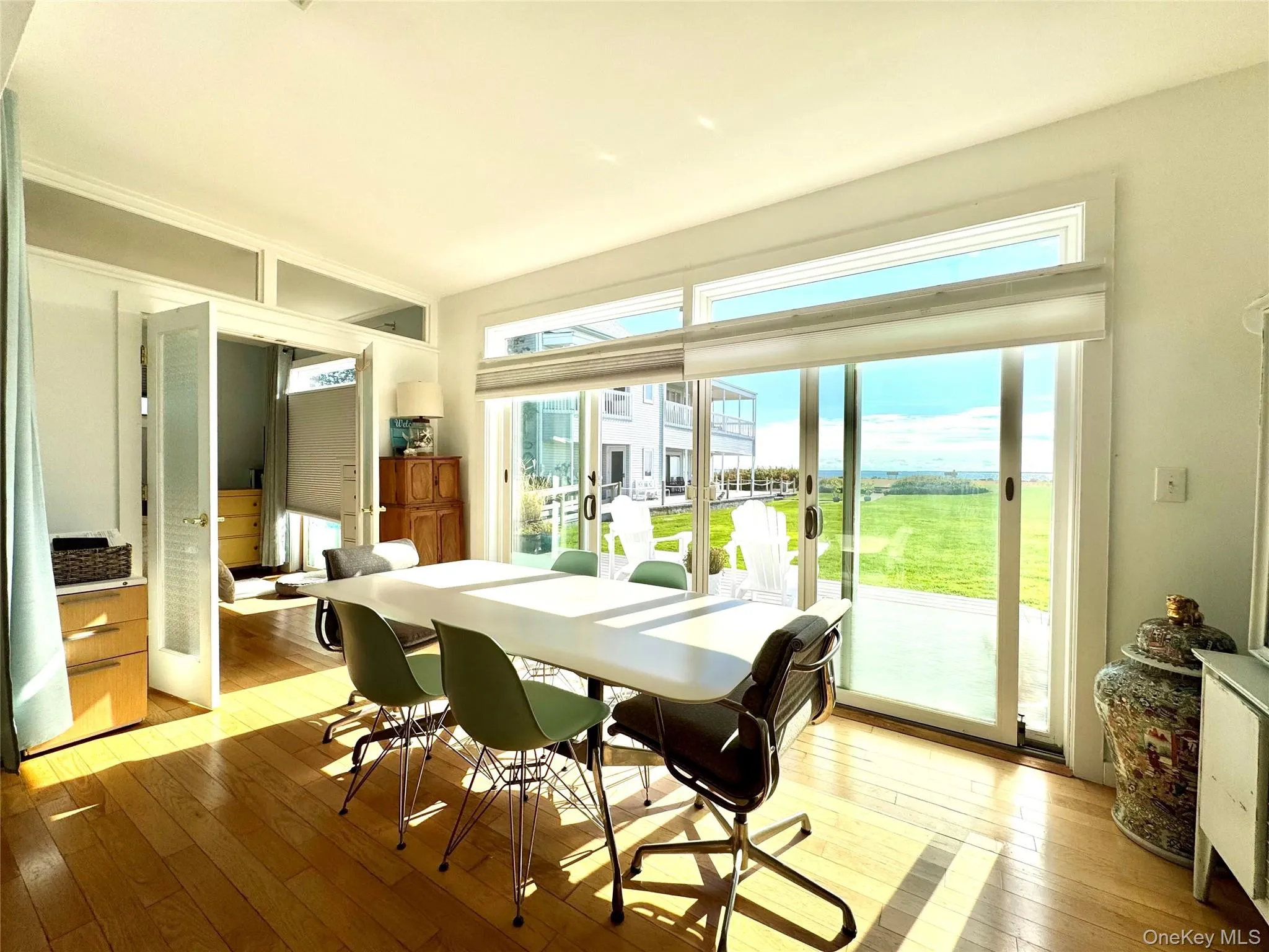 Dining area with light wood-style floors, french doors, and plenty of natural light Dining area with light wood-style floors, french doors, and plenty of natural light