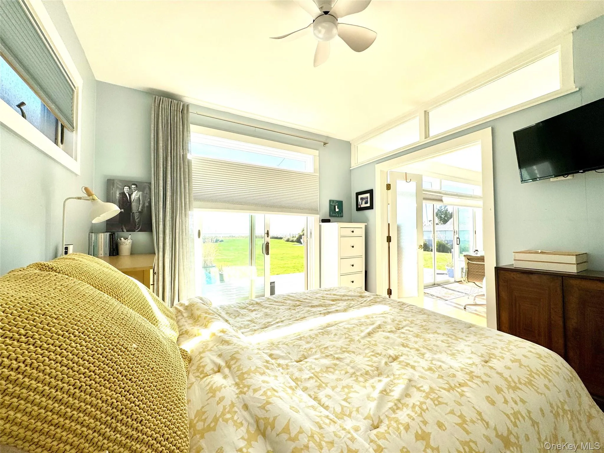 Bedroom featuring access to outside and a ceiling fan Bedroom featuring access to outside and a ceiling fan