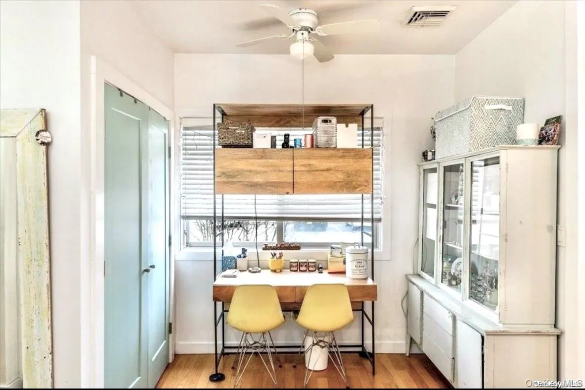 Dining room with wood finished floors and a ceiling fan Dining room with wood finished floors and a ceiling fan