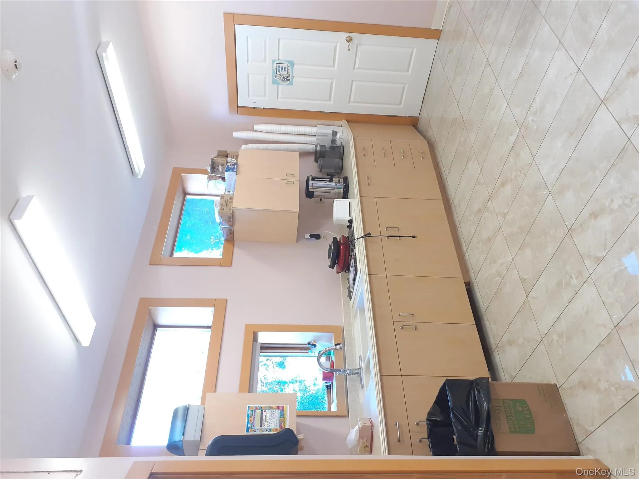 Kitchen with healthy amount of natural light, light brown cabinetry, and light countertops Kitchen with healthy amount of natural light, light brown cabinetry, and light countertops