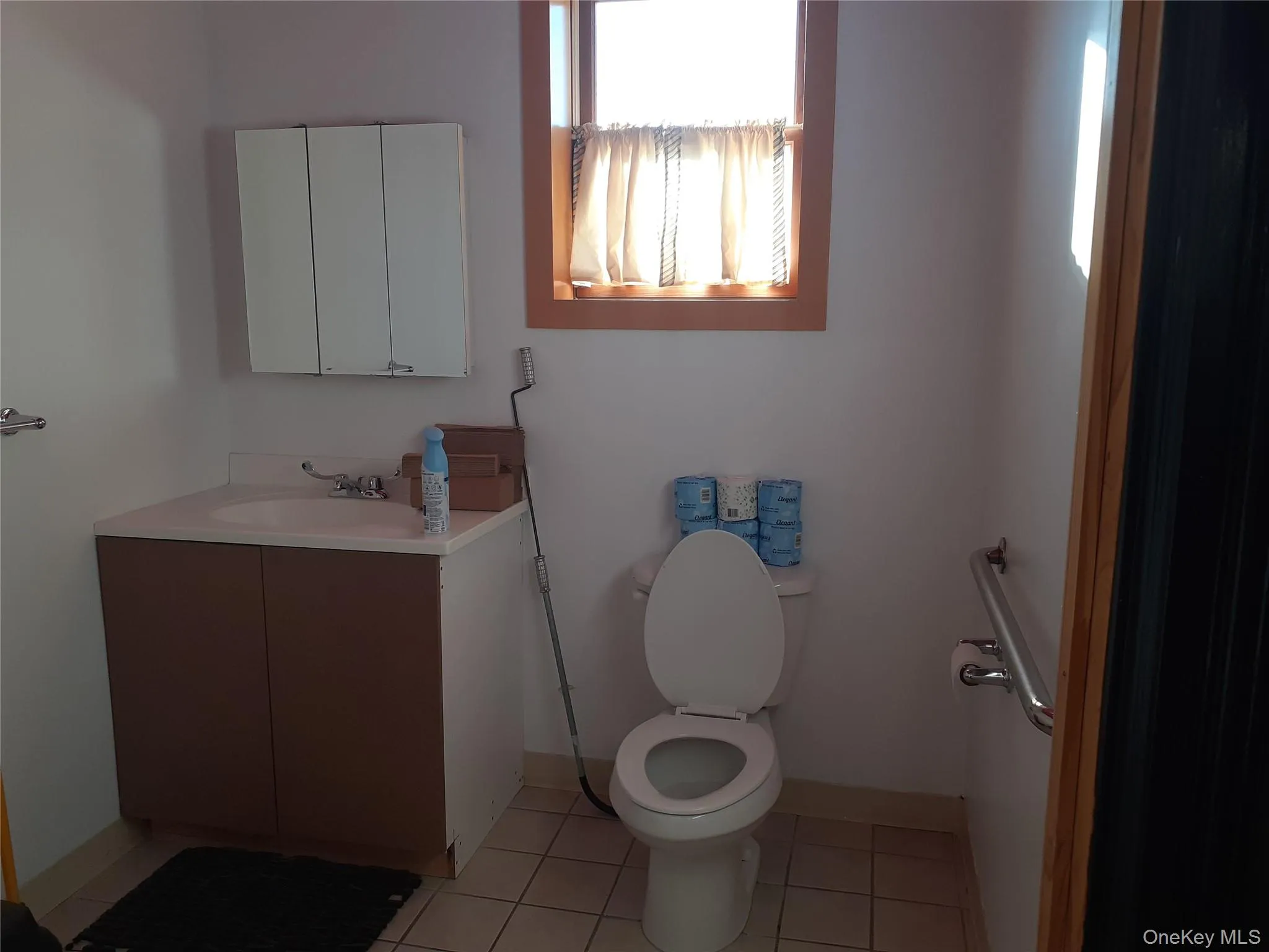 Bathroom with light tile patterned floors and vanity Bathroom with light tile patterned floors and vanity