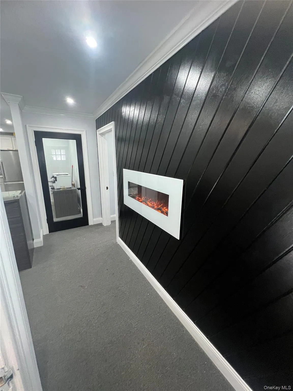 Hall featuring ornamental molding, dark colored carpet, and recessed lighting Hall featuring ornamental molding, dark colored carpet, and recessed lighting