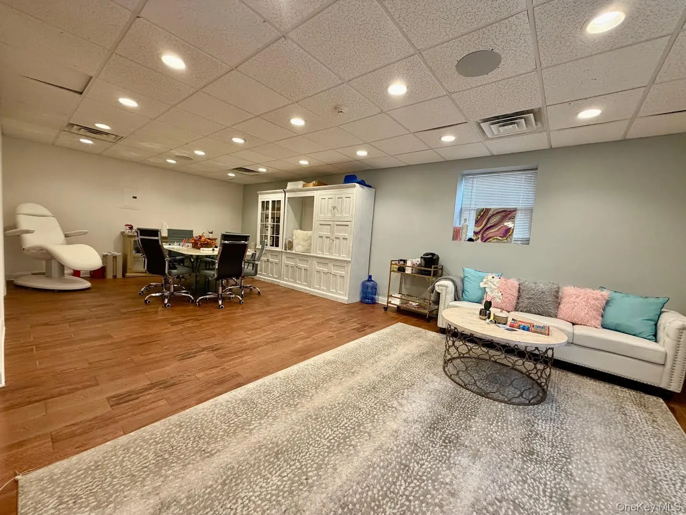 Reception room with a drop ceiling, wood finished floors, and recessed lighting Reception room with a drop ceiling, wood finished floors, and recessed lighting