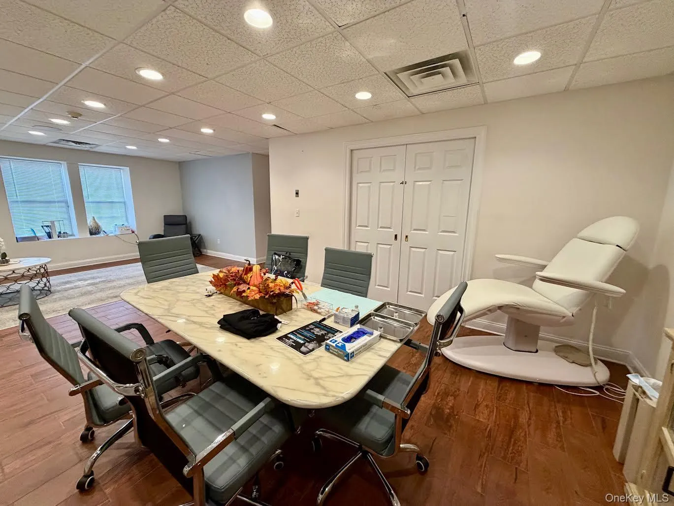 Office area featuring a drop ceiling, recessed lighting, and dark wood-type flooring Office area featuring a drop ceiling, recessed lighting, and dark wood-type flooring