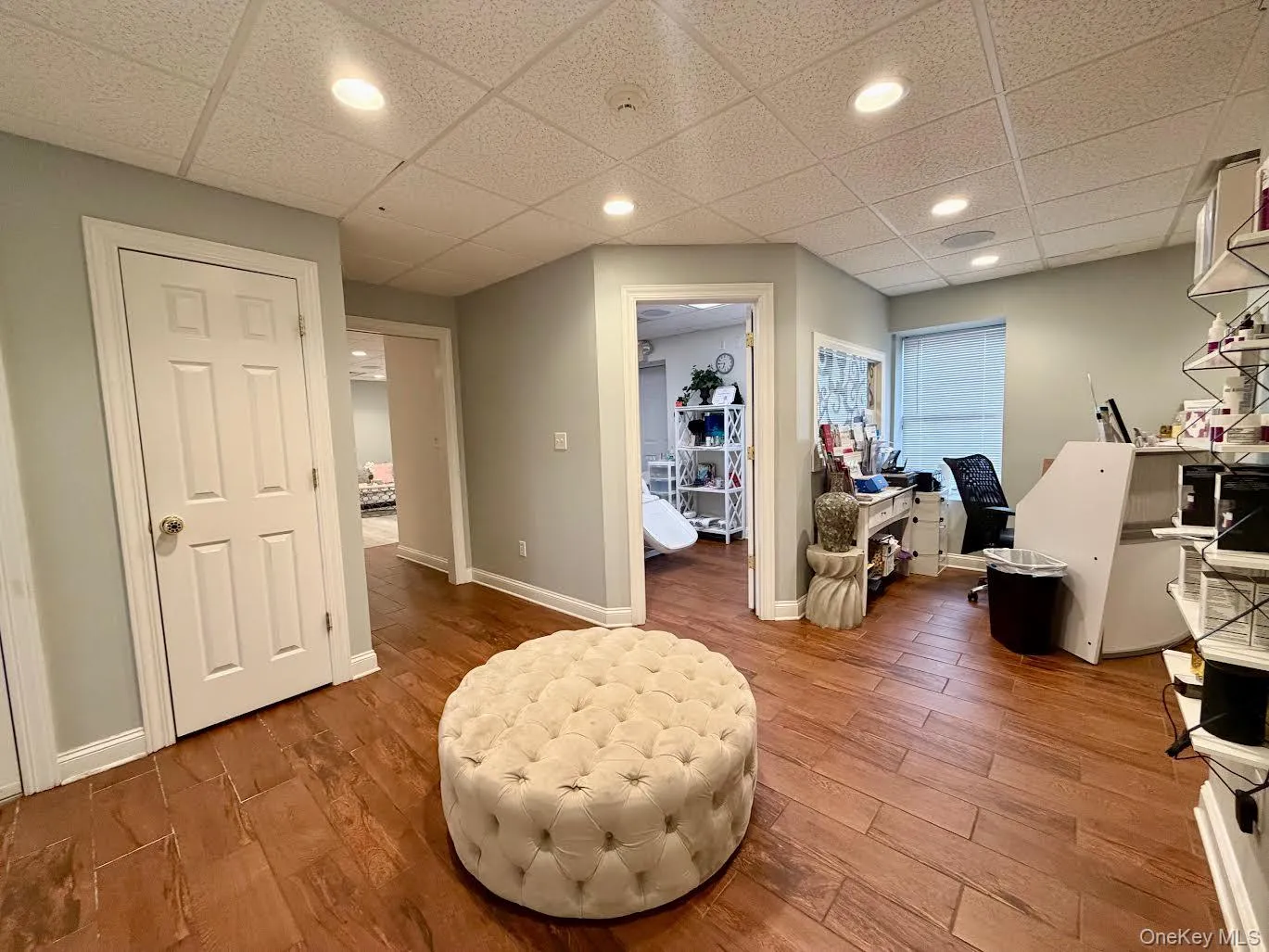 Living area featuring a drop ceiling, wood finished floors, and recessed lighting Living area featuring a drop ceiling, wood finished floors, and recessed lighting