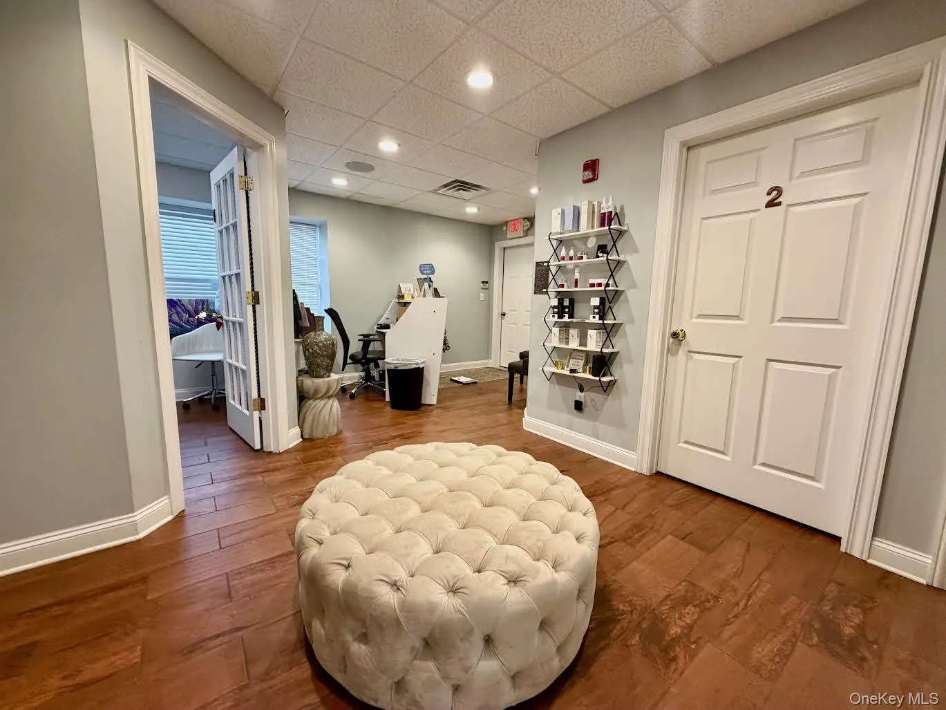 Sitting room featuring a drop ceiling, recessed lighting, and a desk Sitting room featuring a drop ceiling, recessed lighting, and a desk