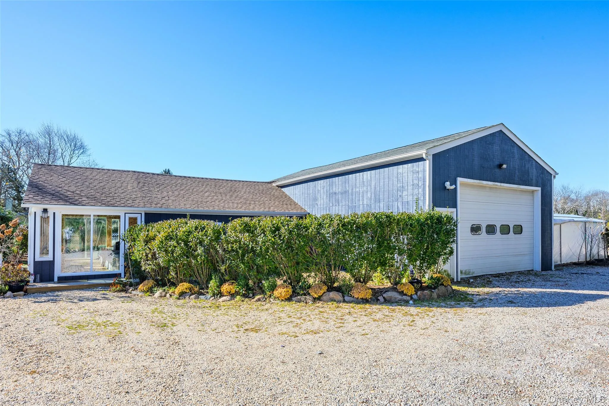 View of front of garage with an outbuilding View of front of garage with an outbuilding