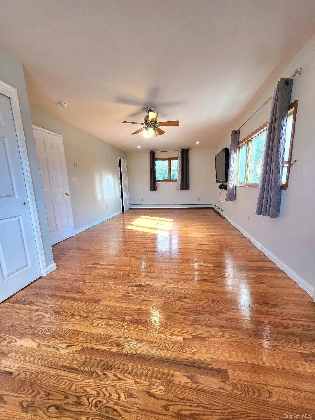 Unfurnished living room with light wood-style floors and ceiling fan Unfurnished living room with light wood-style floors and ceiling fan