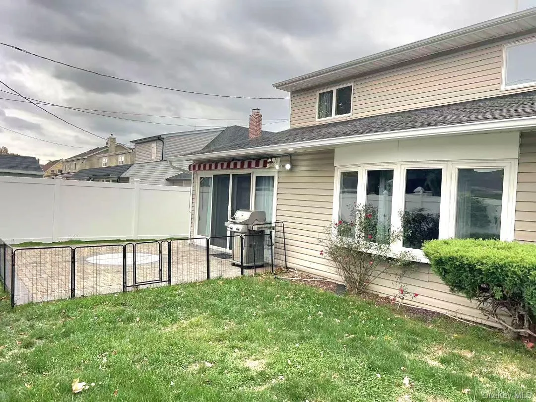 Back of property featuring a chimney Back of property featuring a chimney