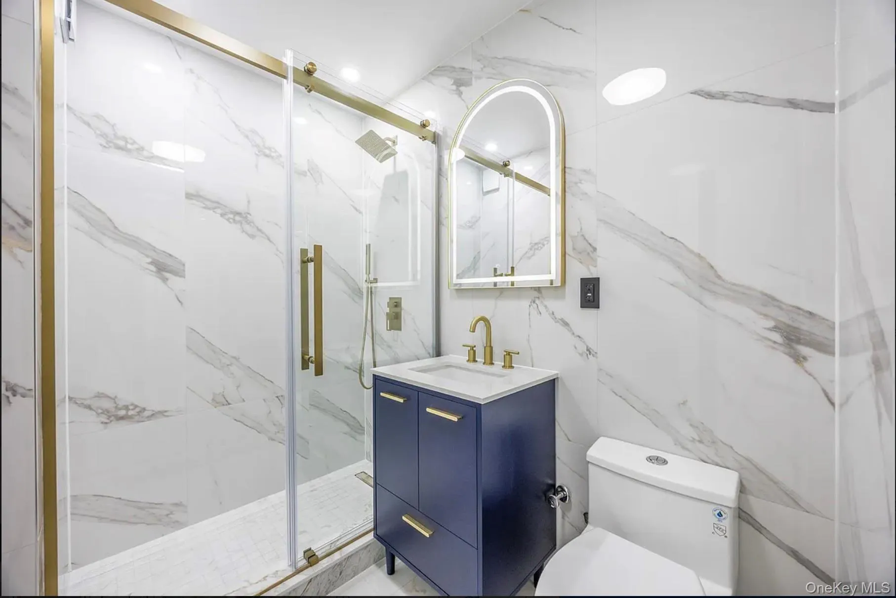 Bathroom with vanity and a marble finish shower Bathroom with vanity and a marble finish shower