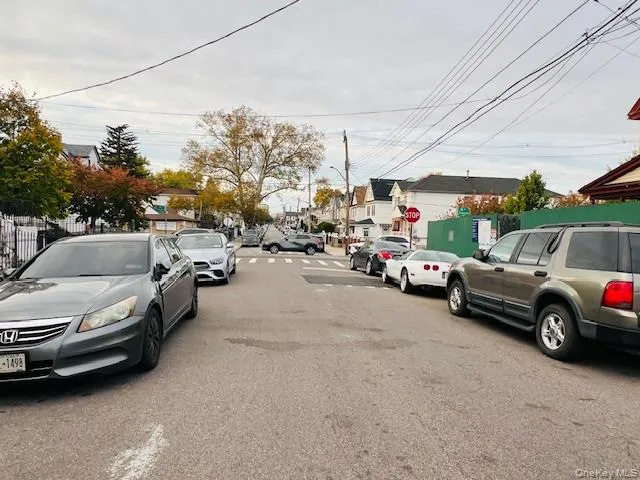 View of asphalt road with street lights, traffic signs, and a residential view View of asphalt road with street lights, traffic signs, and a residential view