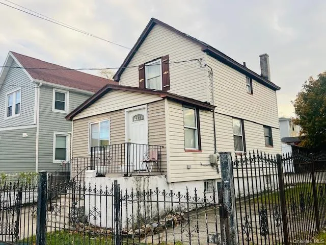 View of front of home featuring a fenced front yard and a gate View of front of home featuring a fenced front yard and a gate