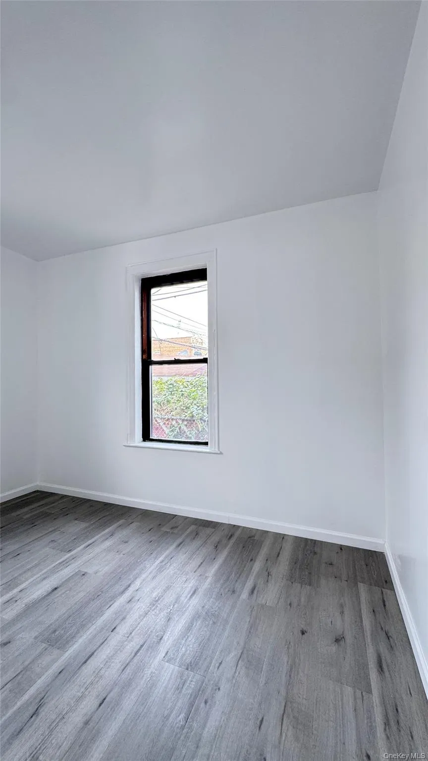 Unfurnished room with light wood-type flooring and baseboards Unfurnished room with light wood-type flooring and baseboards