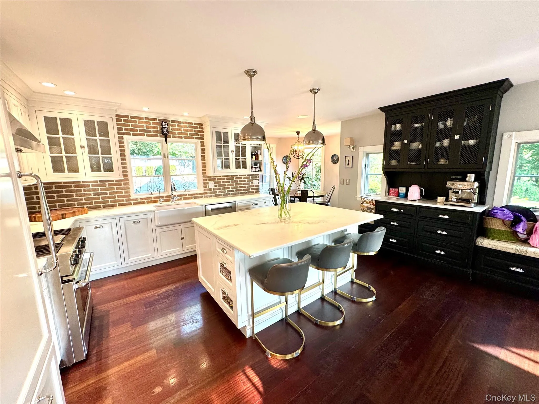 Kitchen with a breakfast bar, glass insert cabinets, pendant lighting, stainless steel appliances. Kitchen with a breakfast bar, glass insert cabinets, pendant lighting, stainless steel appliances.