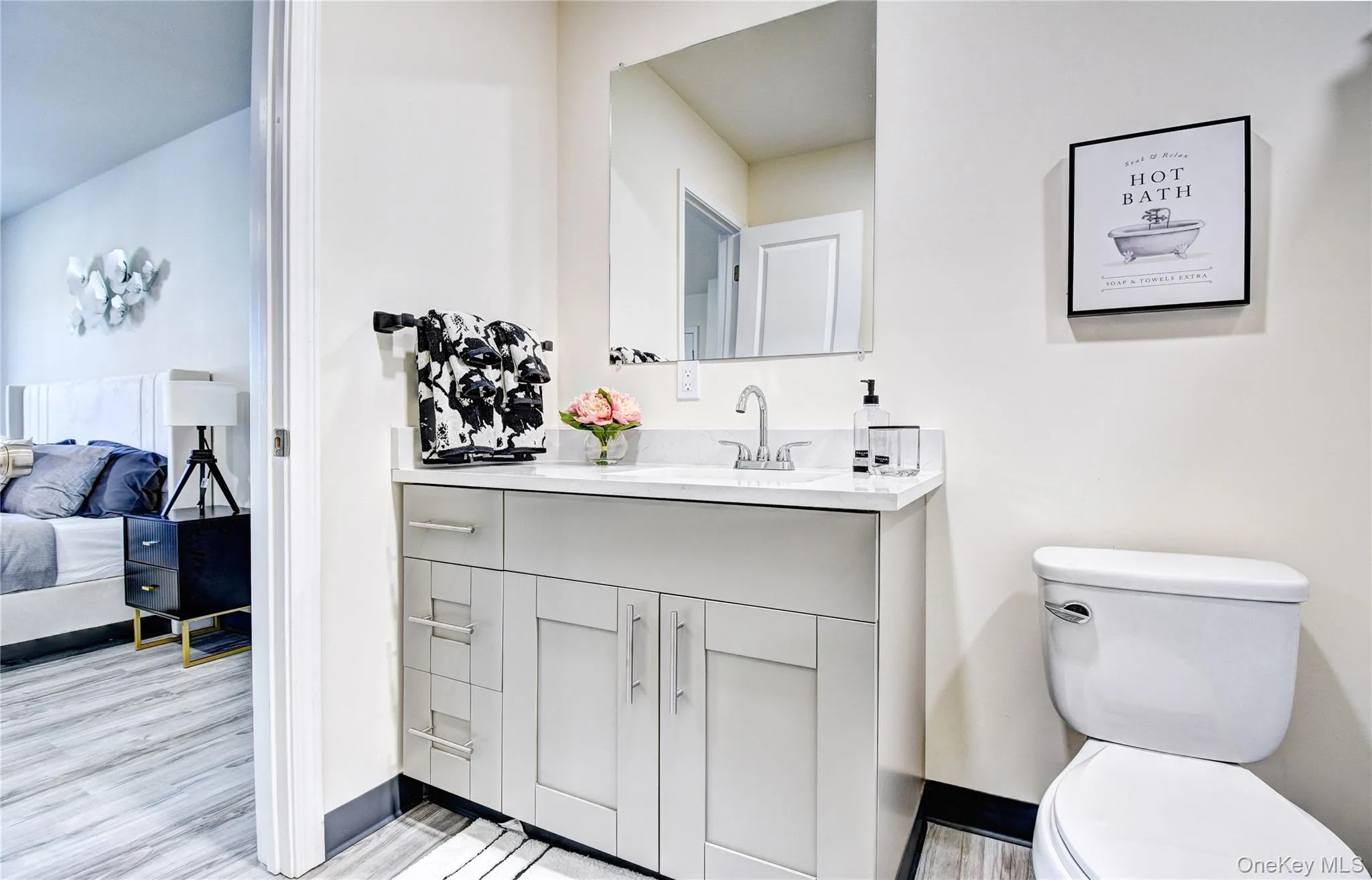 Bathroom with toilet, wood-type flooring, and vanity Bathroom with toilet, wood-type flooring, and vanity