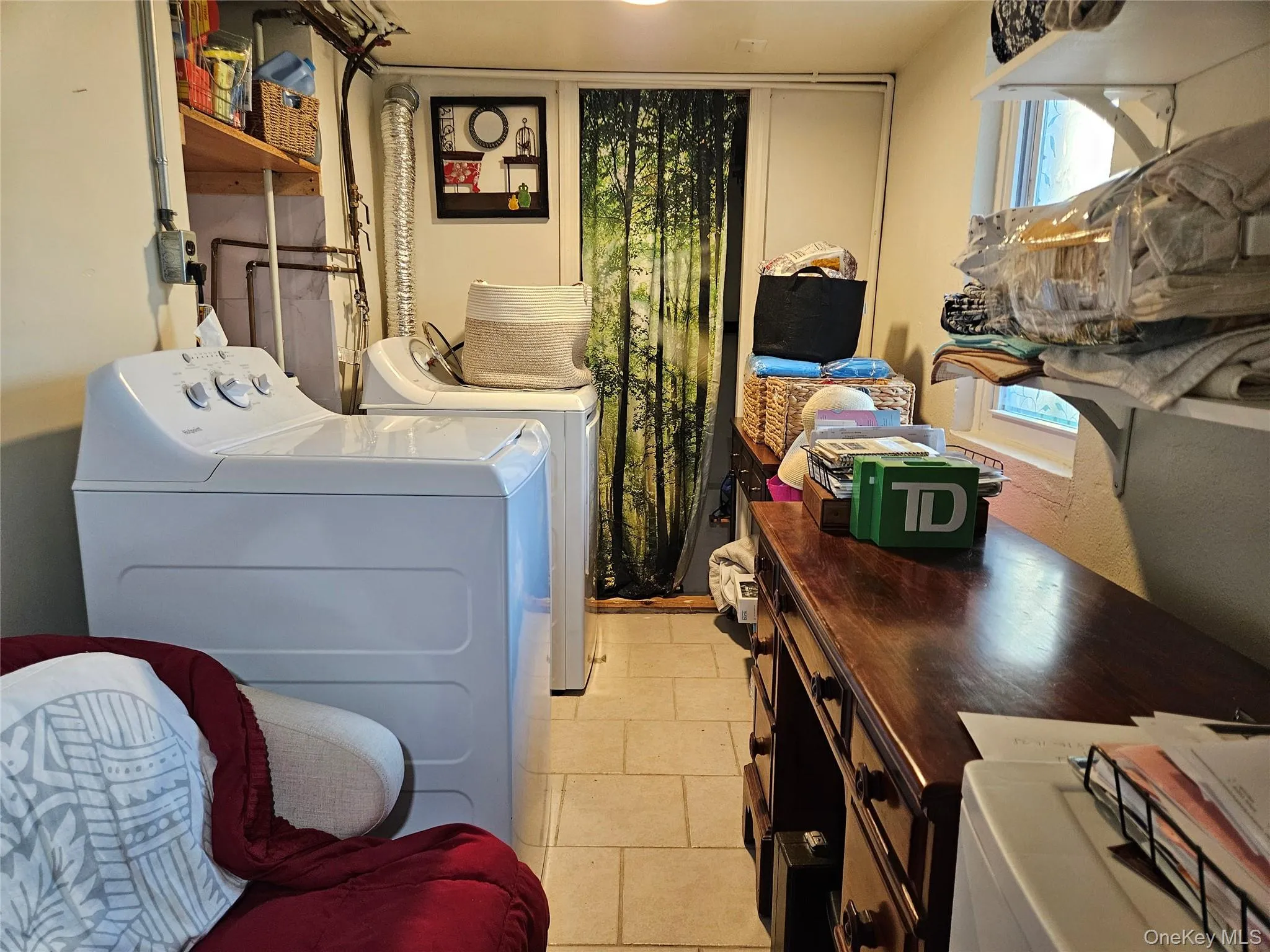 Laundry room featuring separate washer and dryer and storage area. Laundry room featuring separate washer and dryer and storage area.