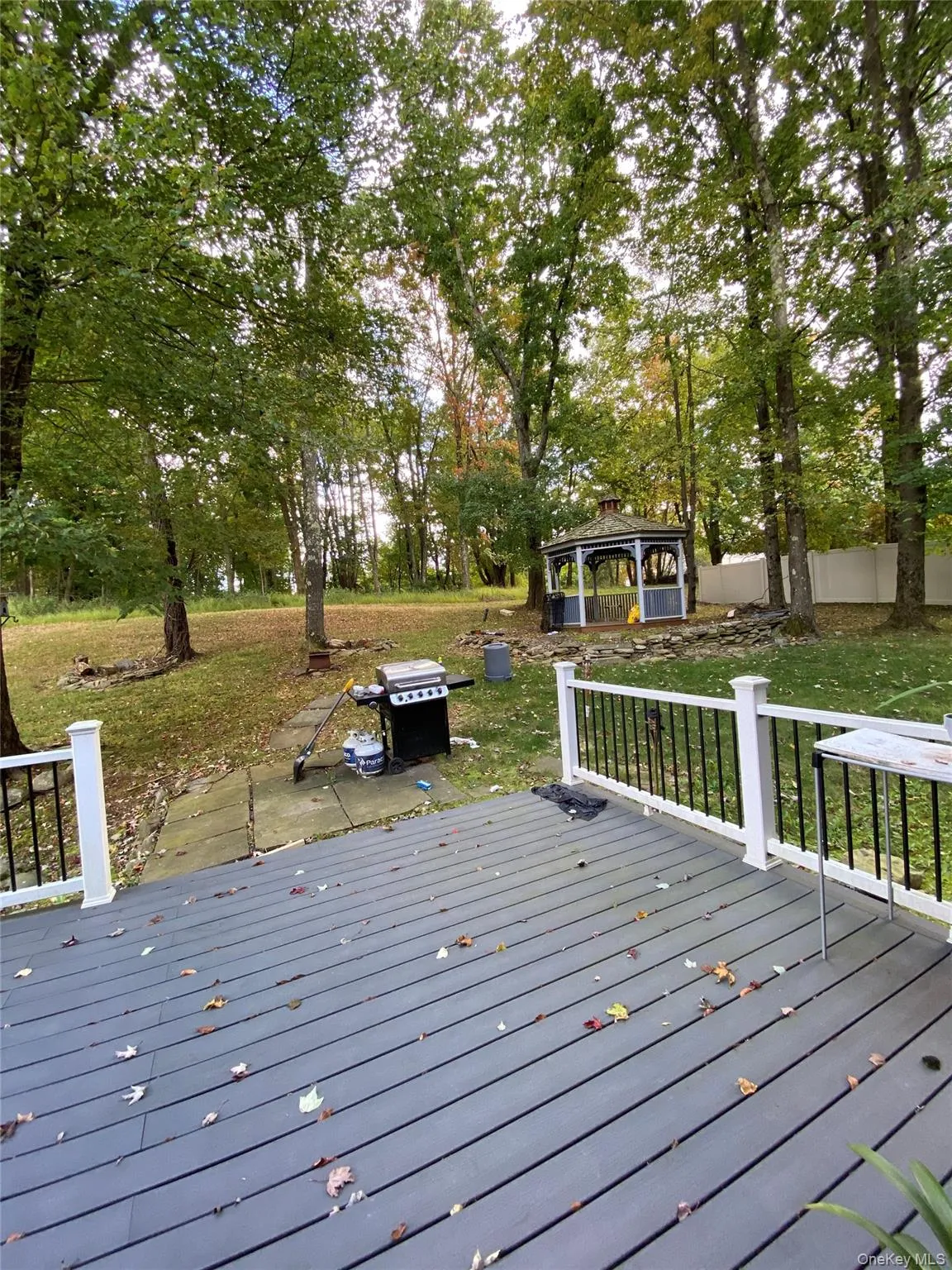 Deck with a gazebo, a yard, area for grilling, and view of wooded area Deck with a gazebo, a yard, area for grilling, and view of wooded area