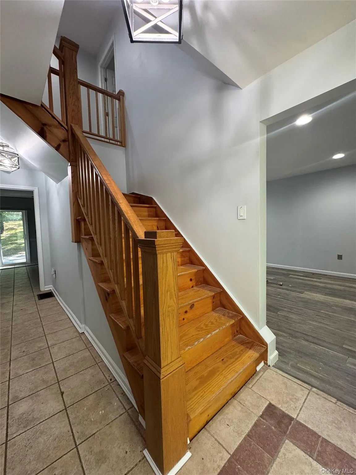 Stairway with baseboards and a high ceiling Stairway with baseboards and a high ceiling