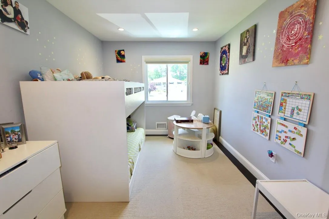 Bedroom featuring a skylight, light carpet, and recessed lighting Bedroom featuring a skylight, light carpet, and recessed lighting