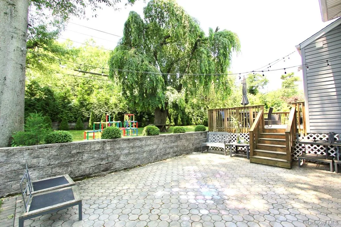 View of patio featuring a playground and a deck View of patio featuring a playground and a deck