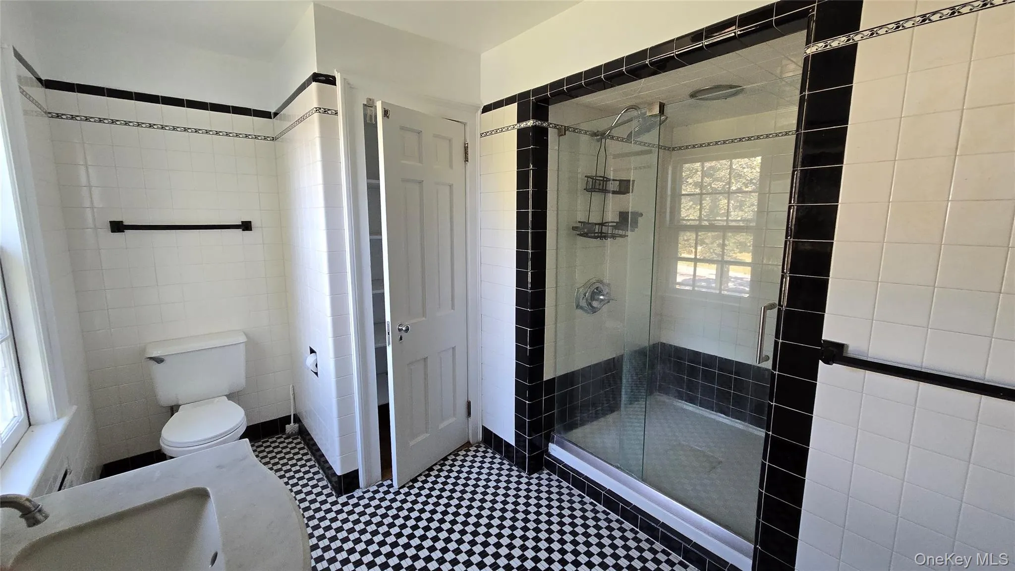 Bathroom featuring tile walls, a stall shower, and vanity Bathroom featuring tile walls, a stall shower, and vanity