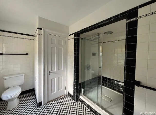 Full bath with tile walls and a shower stall Full bath with tile walls and a shower stall