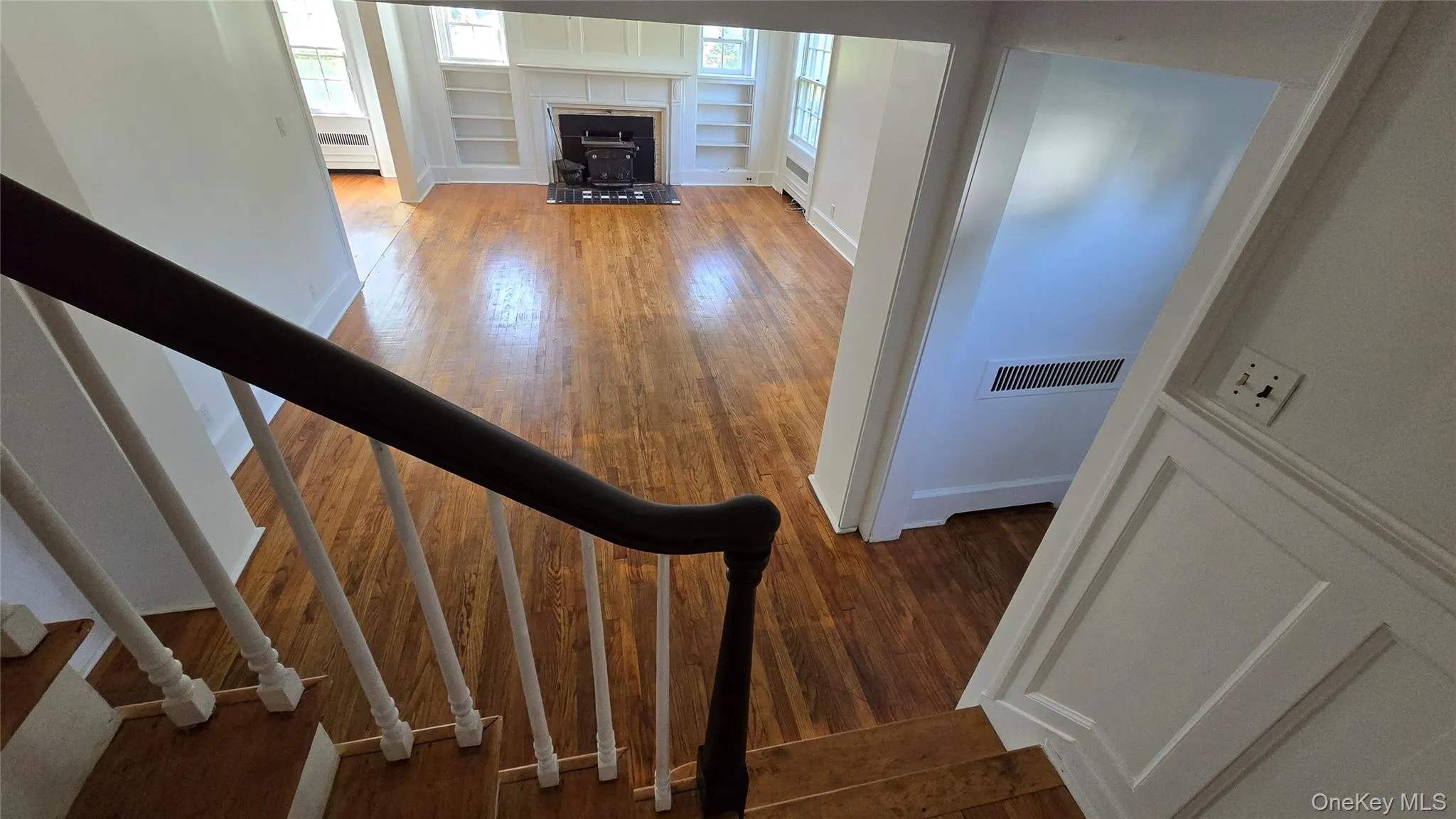 Staircase with wood finished floors and healthy amount of natural light Staircase with wood finished floors and healthy amount of natural light