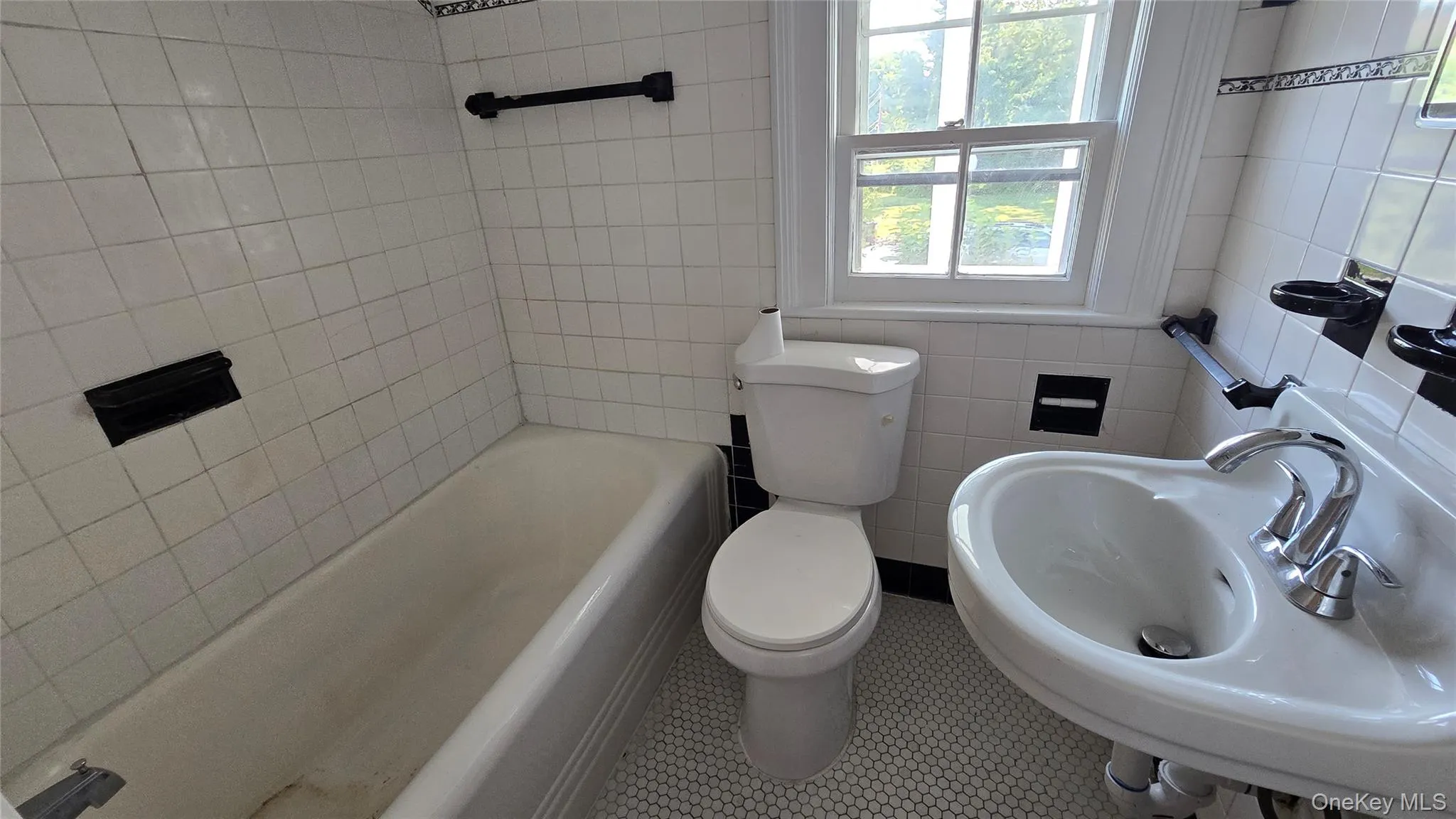 Bathroom with tile walls and toilet Bathroom with tile walls and toilet