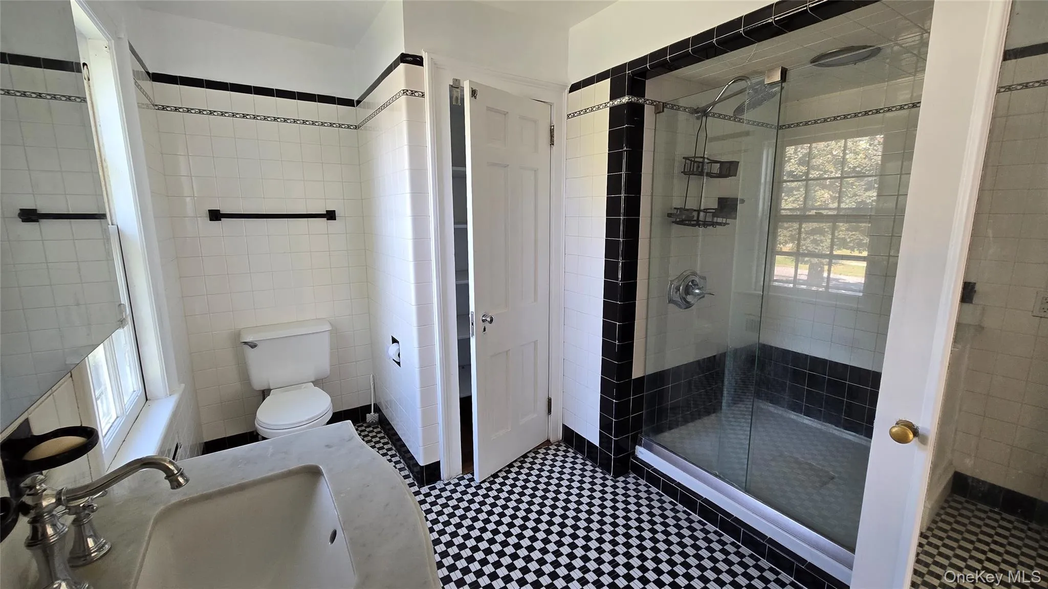 Bathroom with tile walls, a stall shower, and vanity Bathroom with tile walls, a stall shower, and vanity