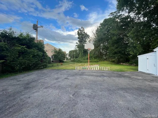 View of road featuring view of wooded area View of road featuring view of wooded area