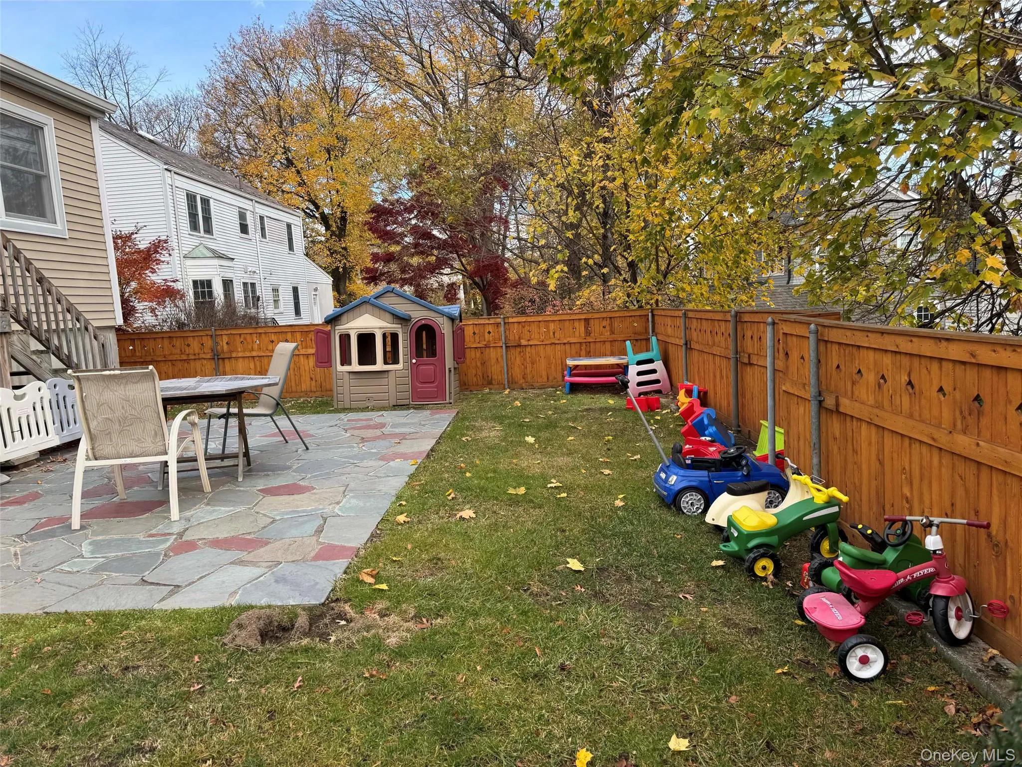 Fenced backyard featuring a patio and a storage unit Fenced backyard featuring a patio and a storage unit