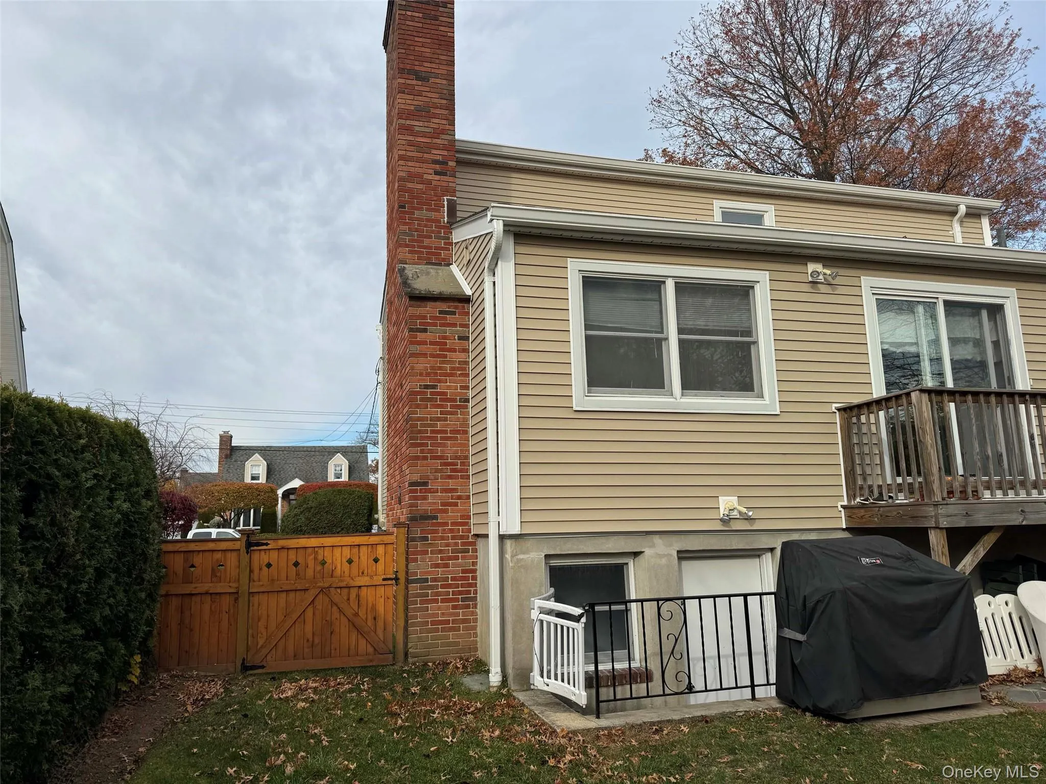Rear view of property featuring a gate and a chimney Rear view of property featuring a gate and a chimney
