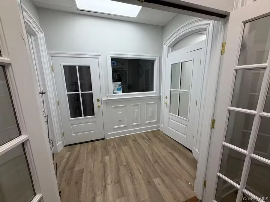 Entryway with wood finished floors Entryway with wood finished floors