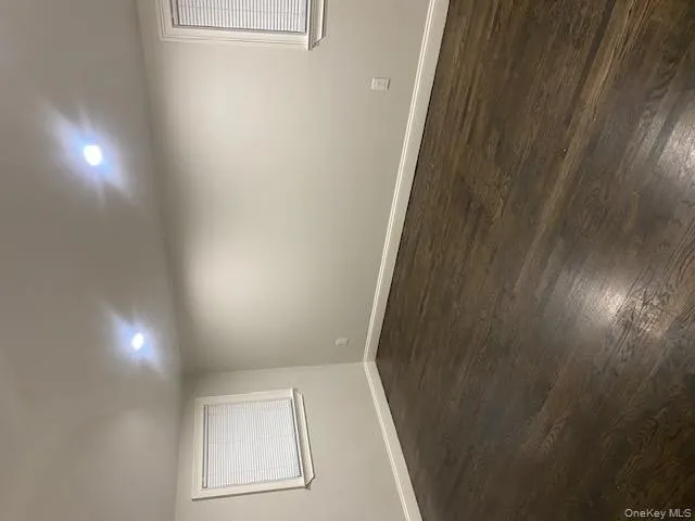 Spare room featuring dark wood-style floors and recessed lighting Spare room featuring dark wood-style floors and recessed lighting