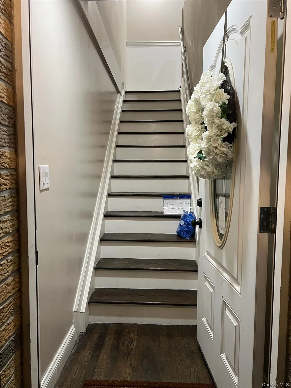 Stairway featuring wood finished floors Stairway featuring wood finished floors