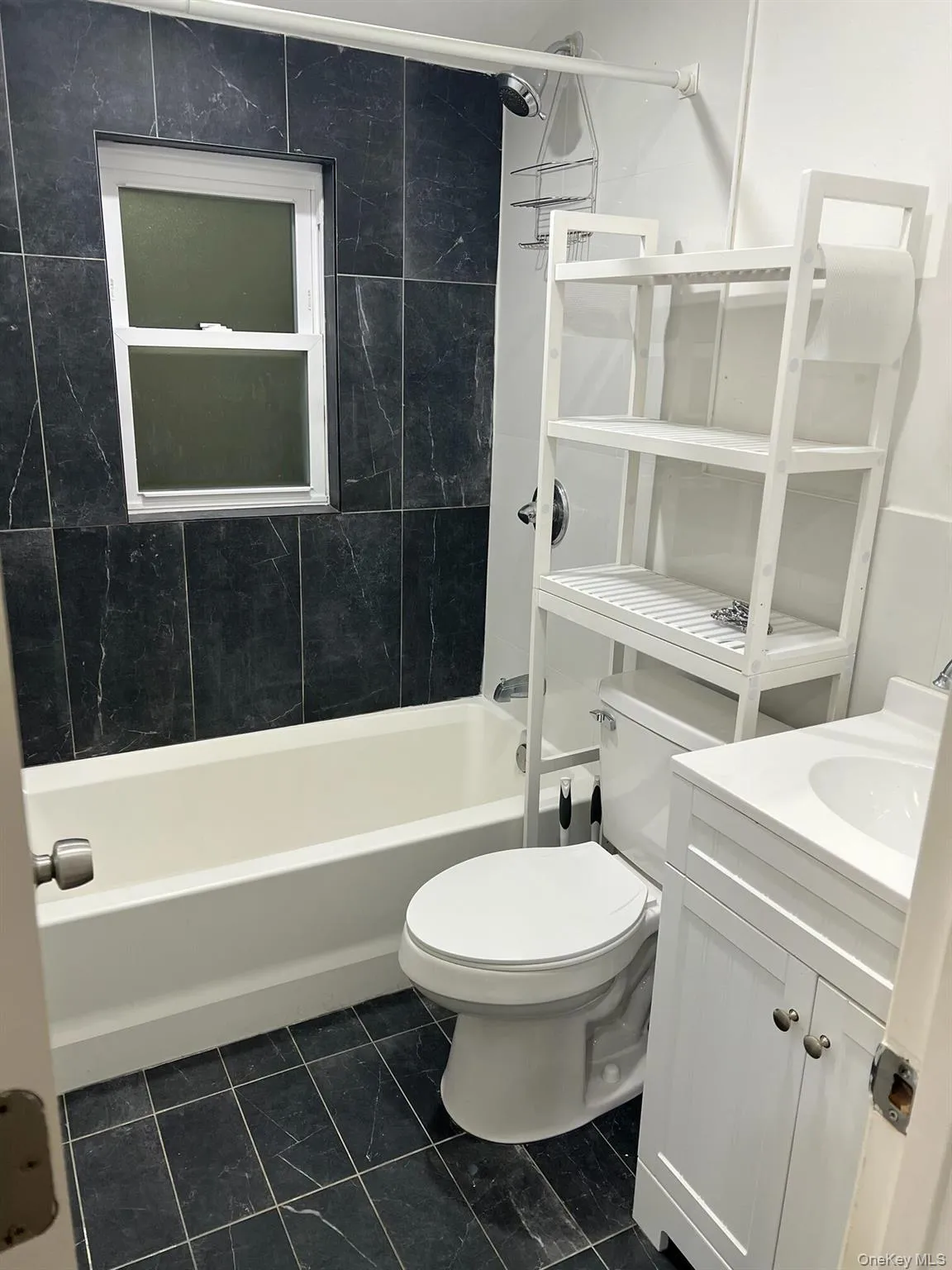 Full bathroom featuring vanity and tub / shower combination Full bathroom featuring vanity and tub / shower combination