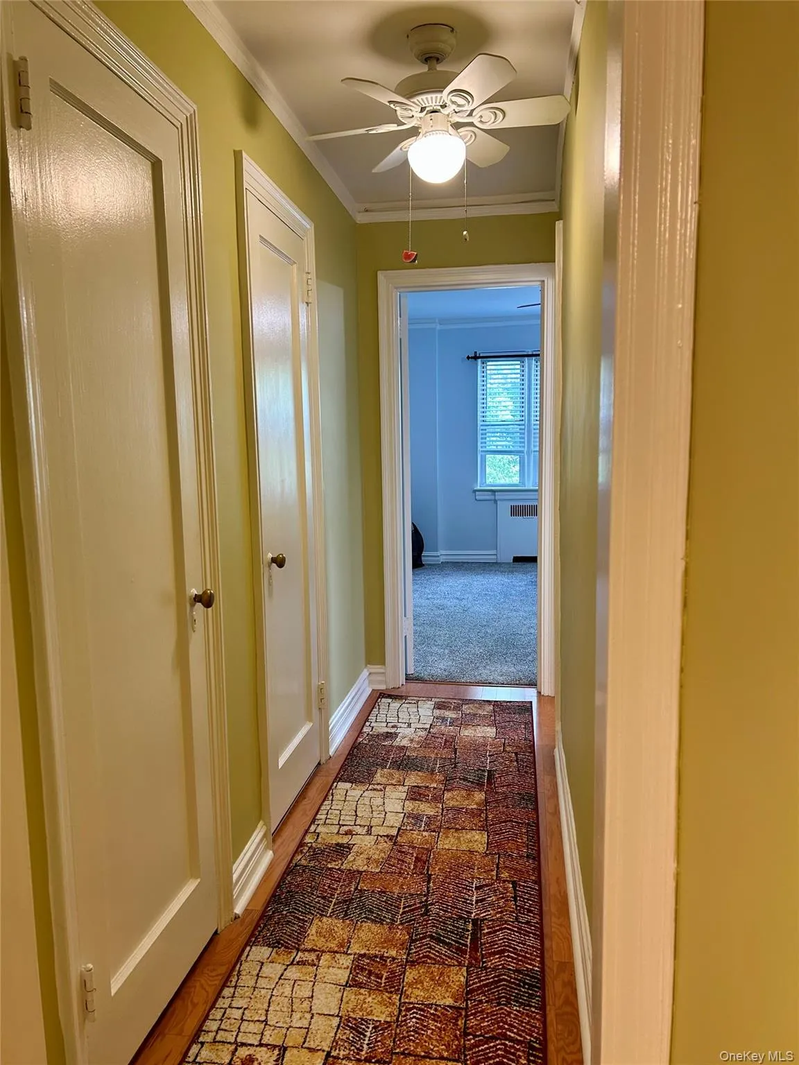 Hallway with ornamental molding leading to the bedroom Hallway with ornamental molding leading to the bedroom