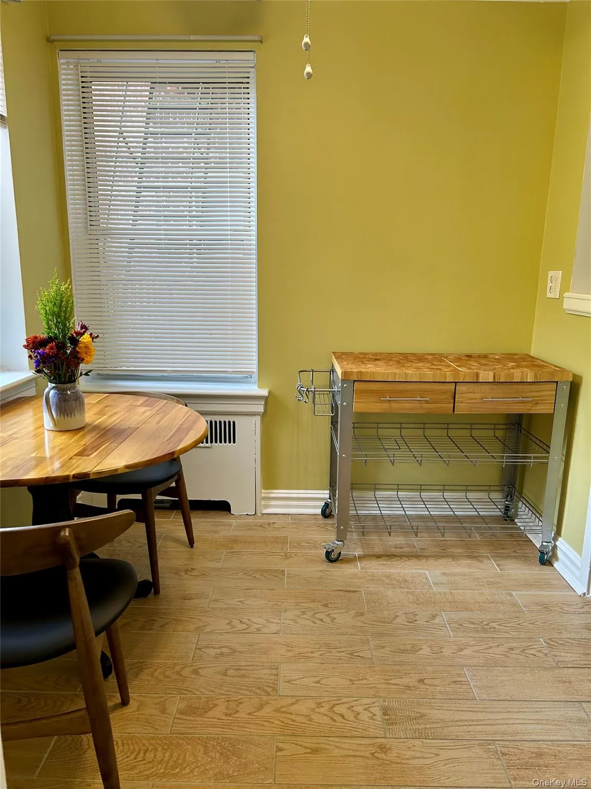 Dining space featuring tile finish floors and radiator heating unit Dining space featuring tile finish floors and radiator heating unit