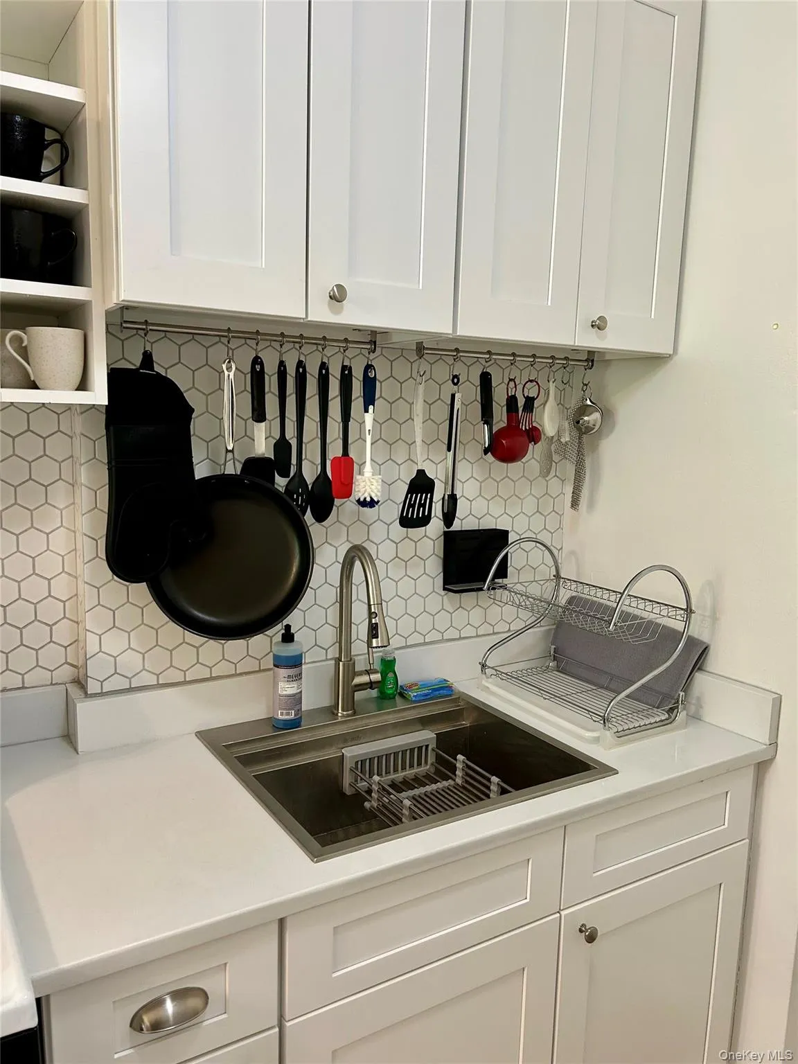 Kitchen with white cabinets, open shelves, decorative backsplash Kitchen with white cabinets, open shelves, decorative backsplash