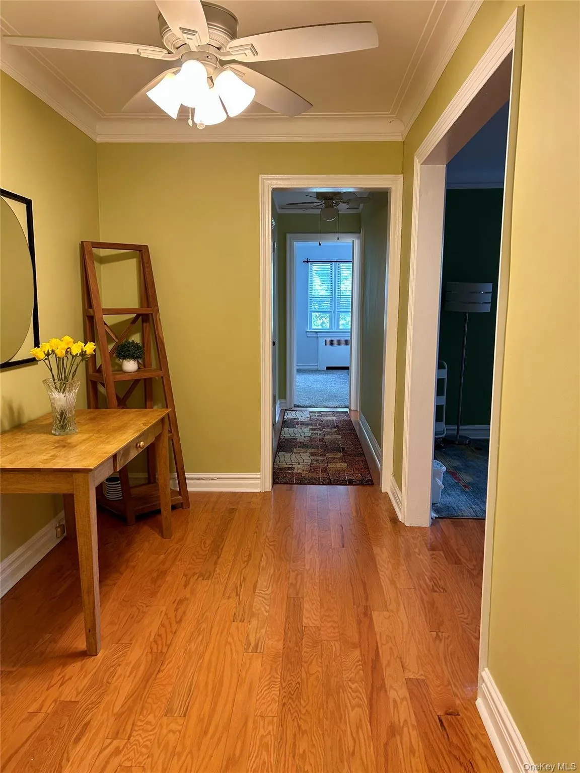 Corridor with ornamental molding and light wood finished floors Corridor with ornamental molding and light wood finished floors