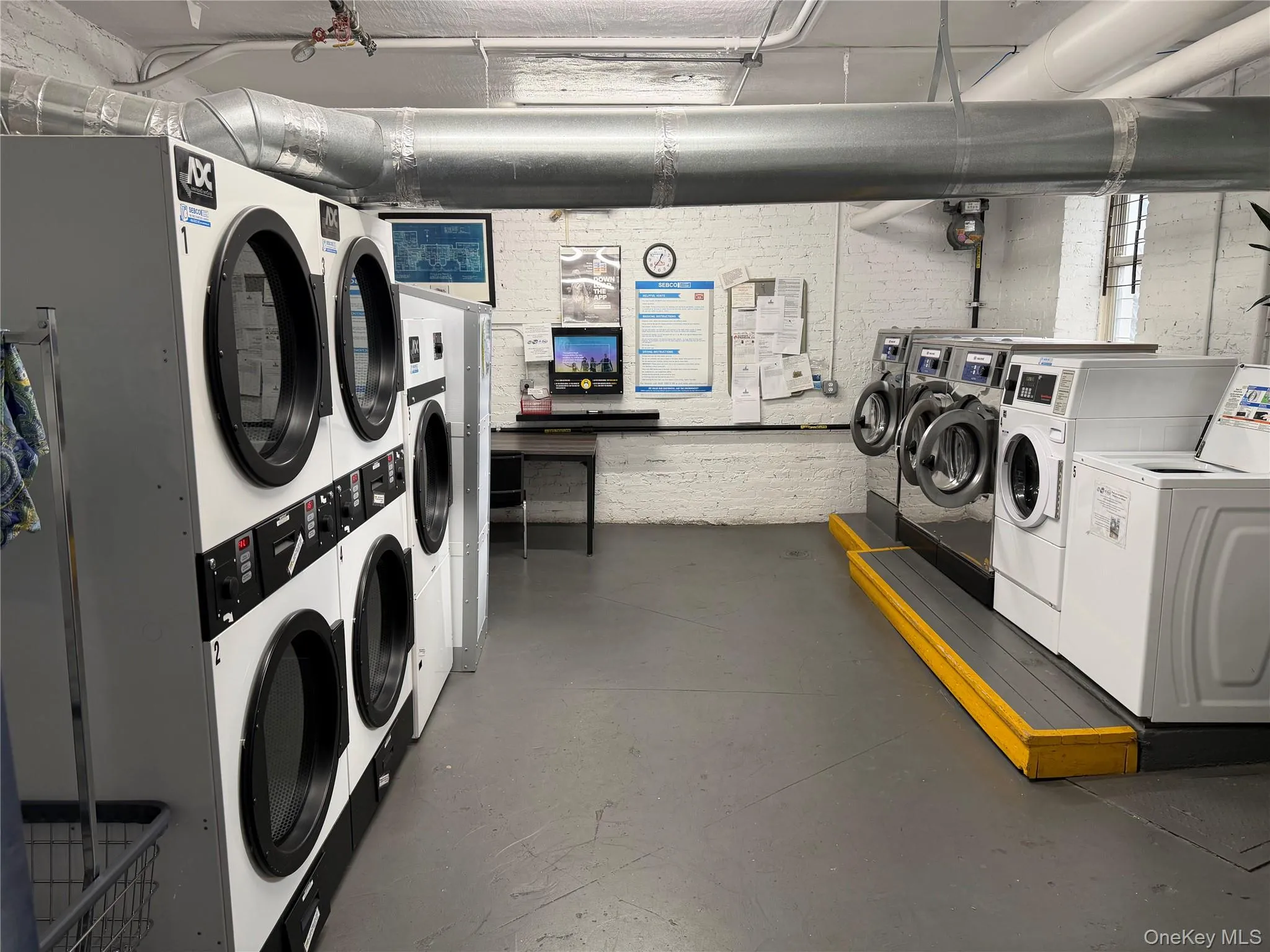 Community laundry room featuring independent washers and dryers located on the basement level Community laundry room featuring independent washers and dryers located on the basement level